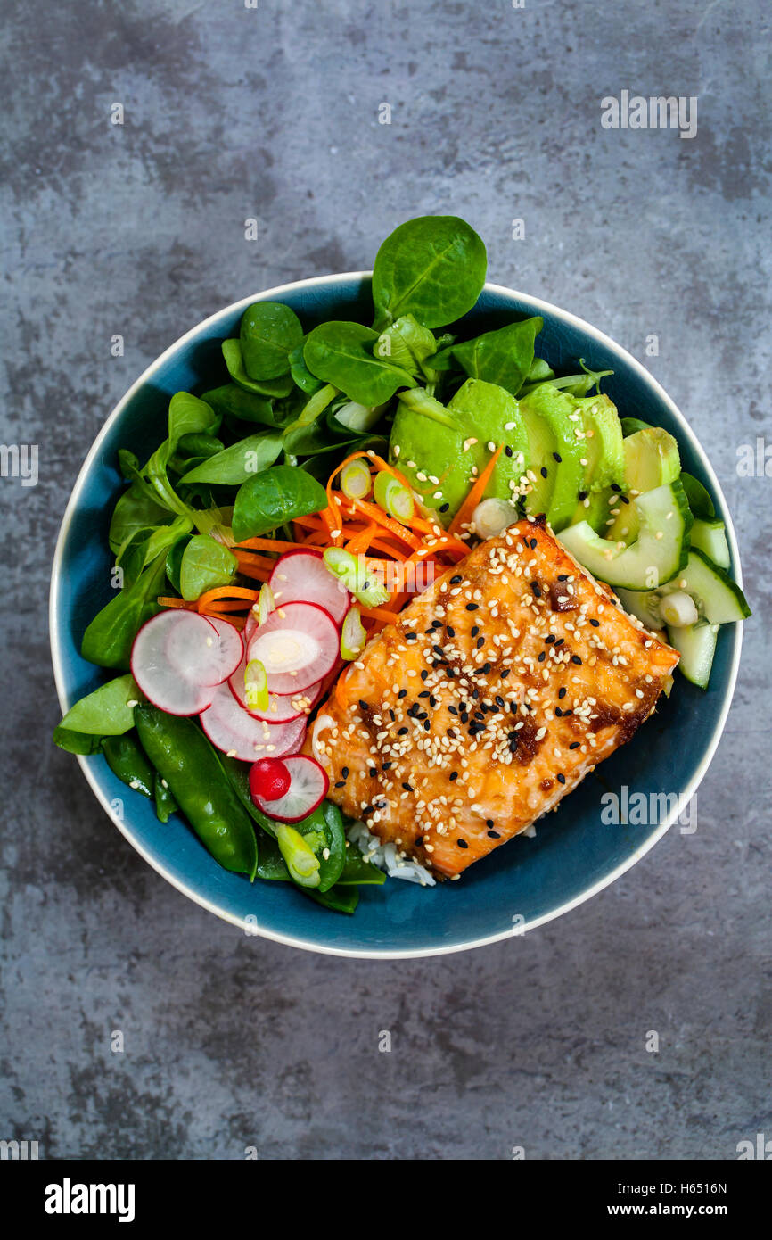 Salmon teriyaki with pickled carrots and radishes, lamb lettuce and avocado  Stock Photo - Alamy
