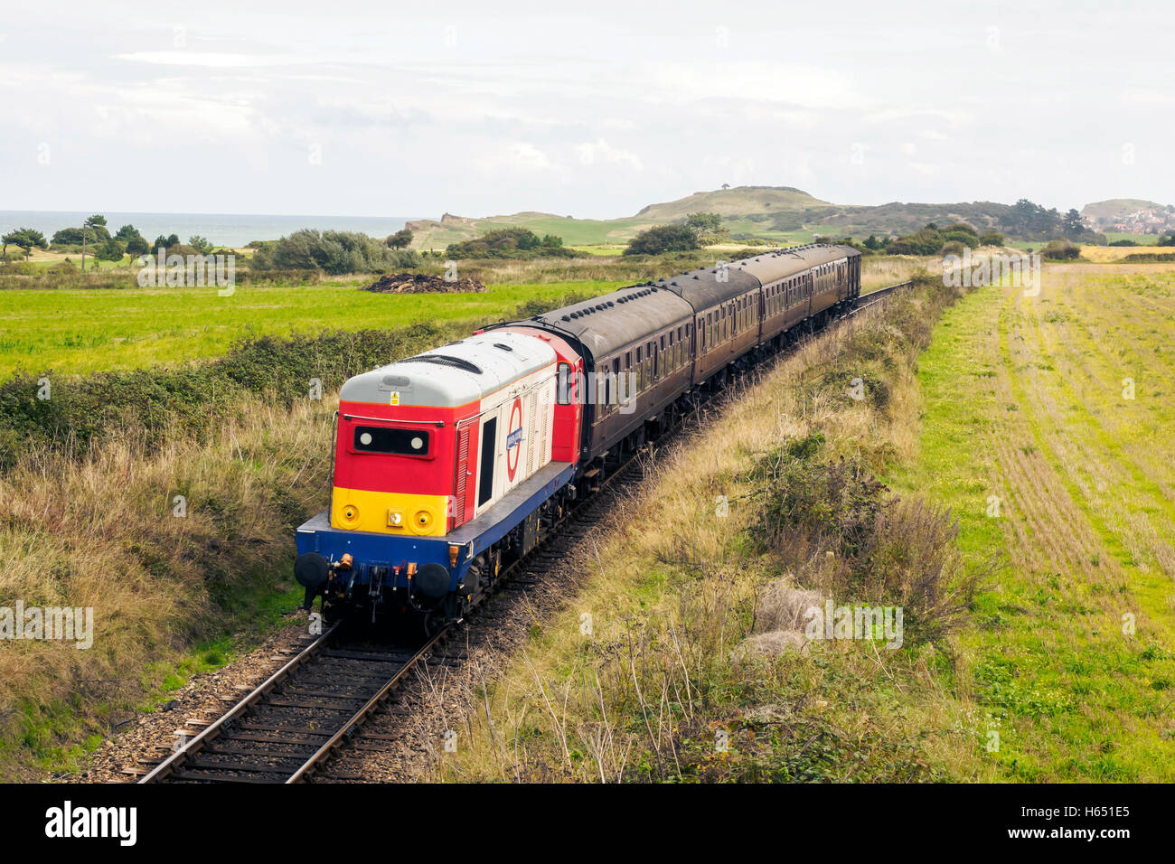 London Underground Class 20 diesel locomotive 20227 on loan to the North Norfolk Railway heads a Holt train up Dead Man's Hill. Stock Photo