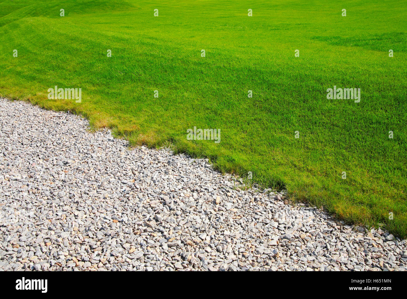 Landscaping, pebbles, gravel and lawn Stock Photo