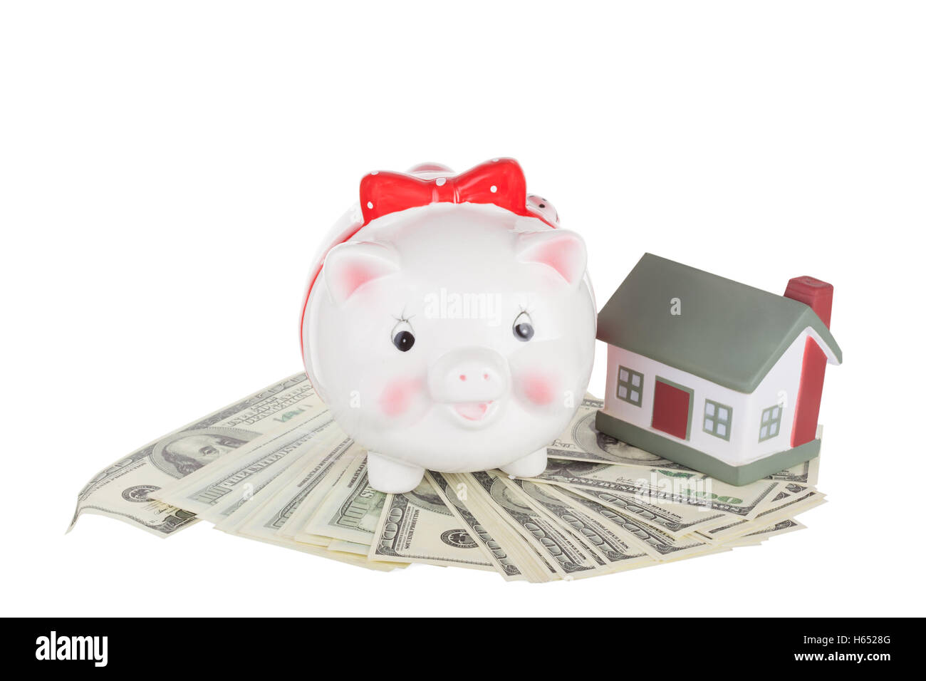 Pig moneybox on money and the toy house Stock Photo