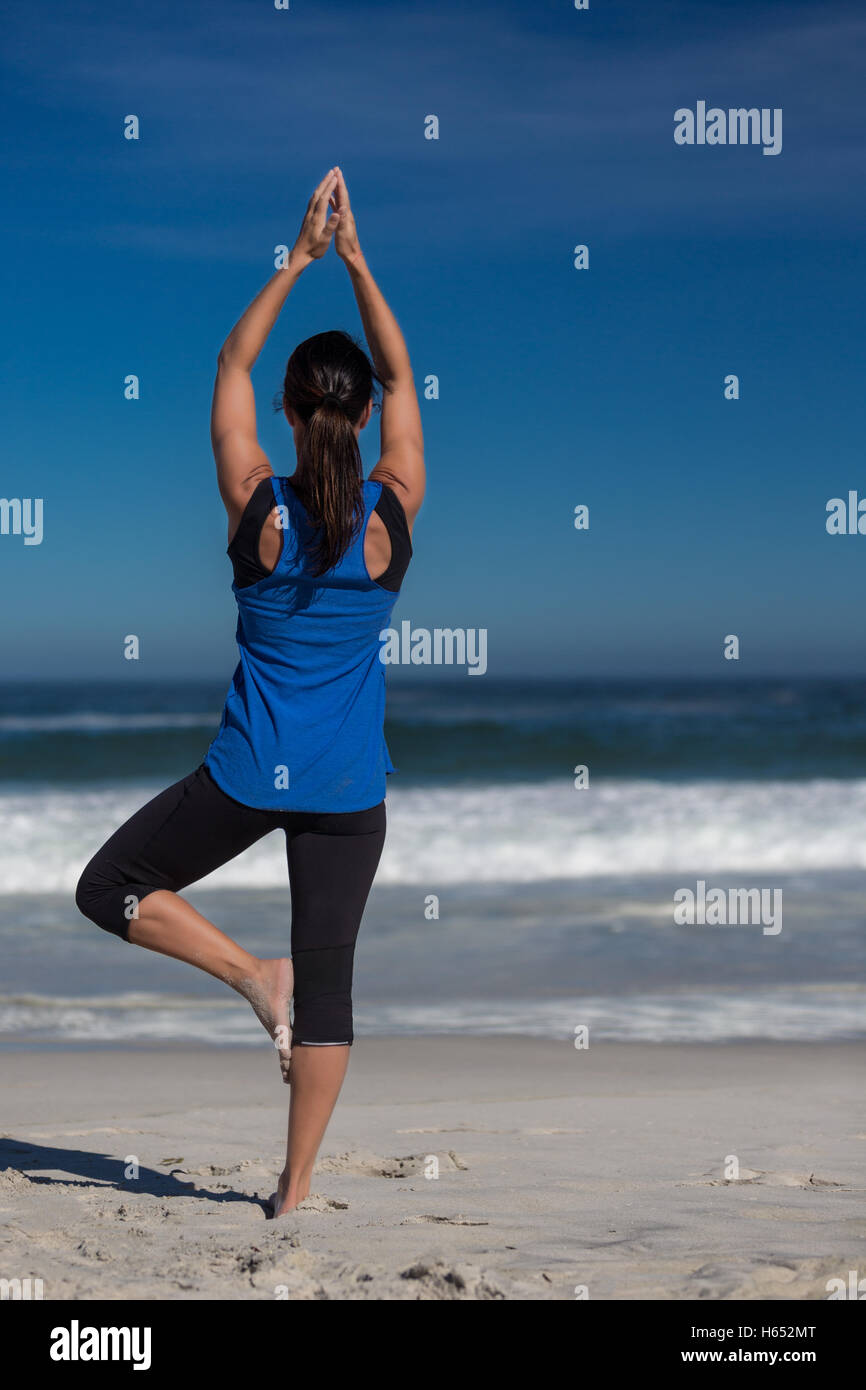 Yoga at the beach Stock Photo