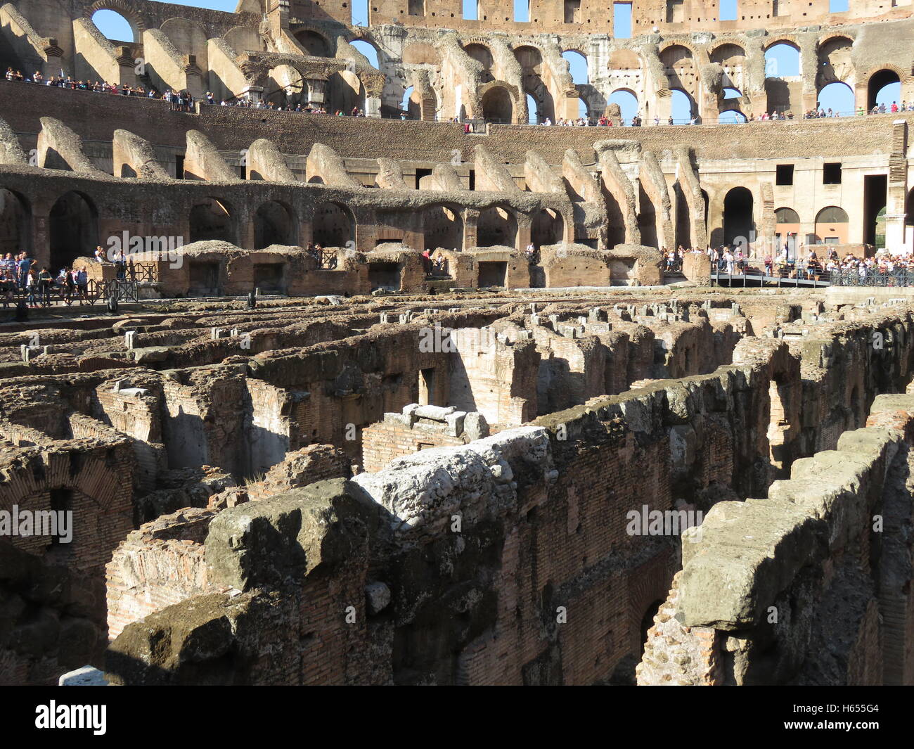 Interior of Colosseum with tourists Stock Photo