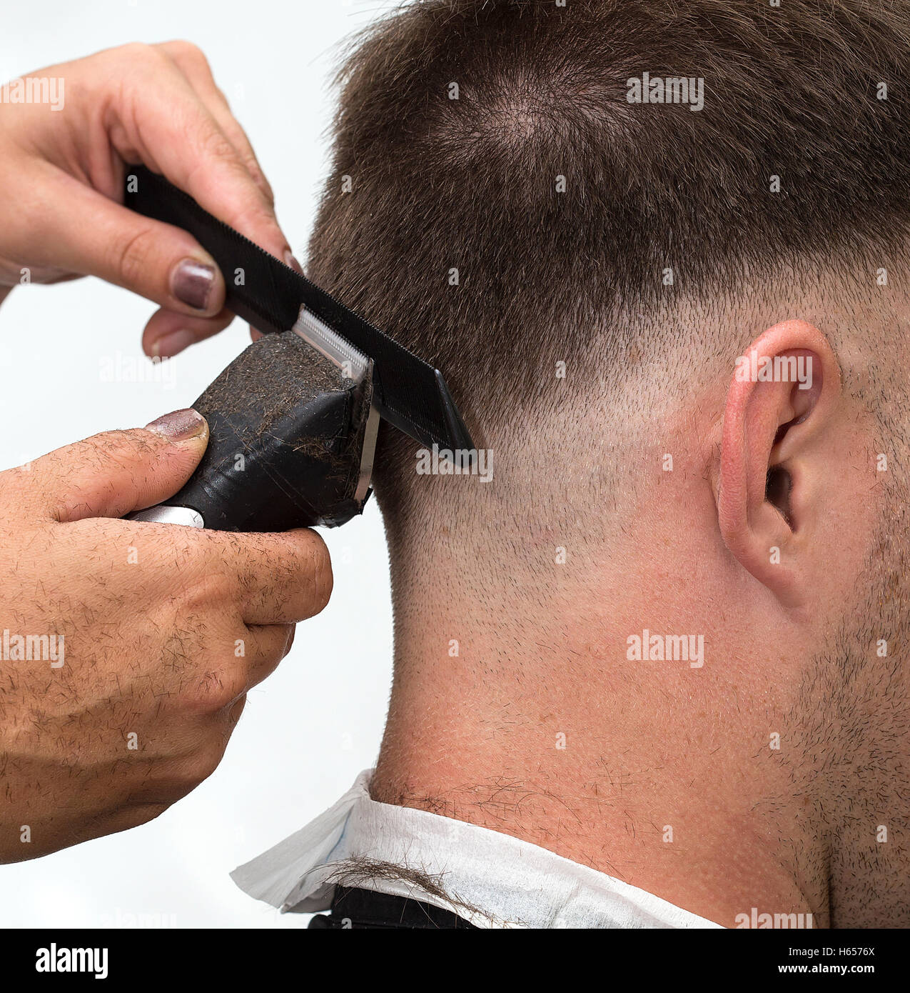 At the hairdresser getting a new male haircut. Stock Photo