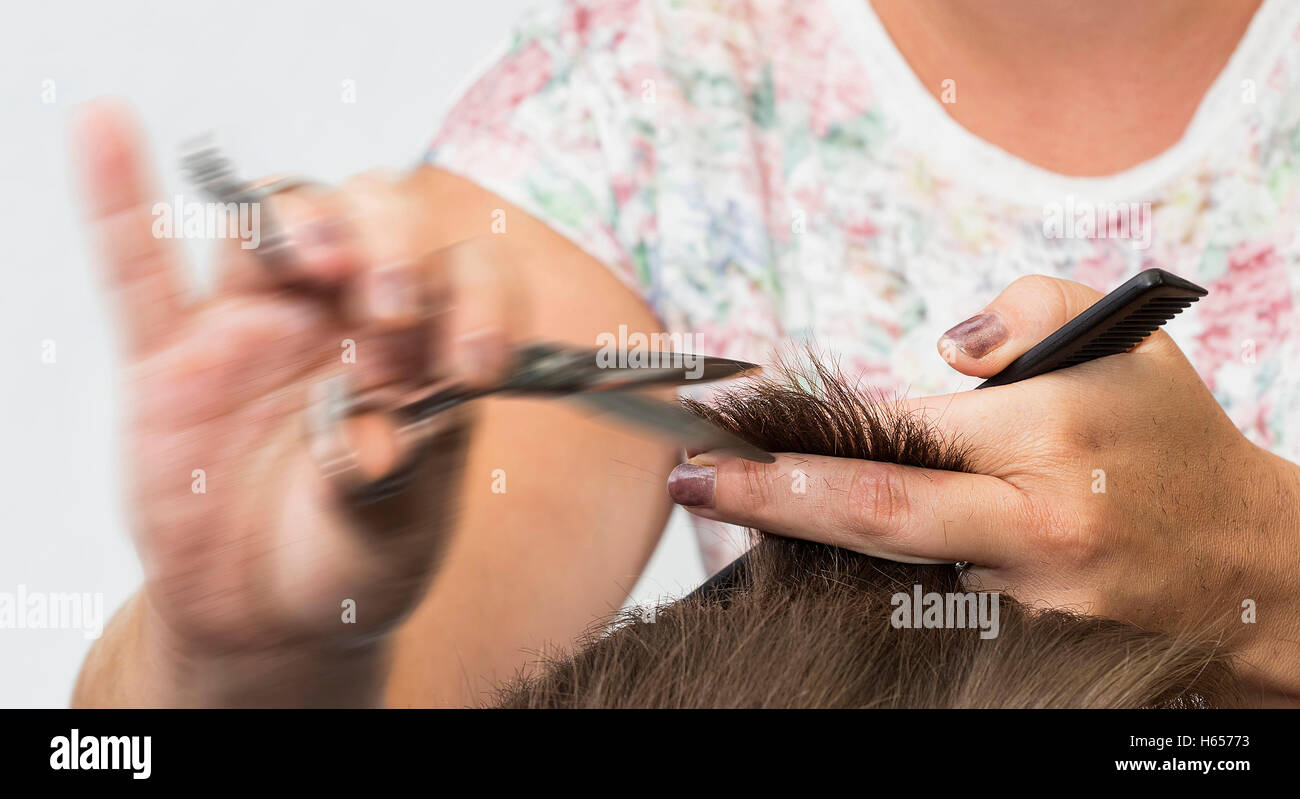 Very fast cutting hair at the hairdressers. Stock Photo