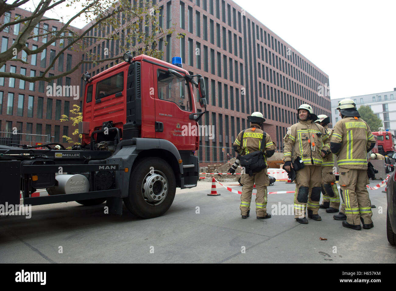 Berlin, Germany. 24th Oct, 2016. Fire fighters with special equipment preparing for their mission in front of the new headquarters of the German intelligence service (Bundesnachrichtendienst, BND) in Berlin, Germany, 24 October 2016. Acid was leaking in a battery room of a still empty office complex. PHOTO: PAUL ZINKEN/dpa/Alamy Live News Stock Photo