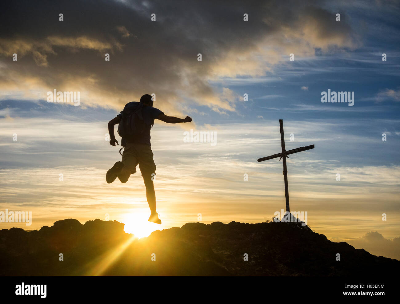 Las Palmas, Gran Canaria, Canary Islands, Spain. 25th Oct, 2016. Weather: Calm before the storm. A hiker at sunrise on volcanic mountain overlooking Las Palmas city on a day when the weather warnings have been issued for most of the Canary Islands for rain and stormy seas. Credit:  Alan Dawson News/Alamy Live News Stock Photo