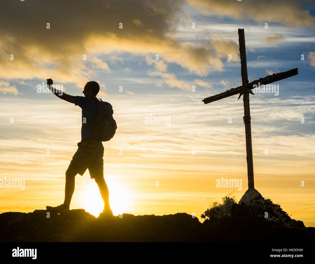 Las Palmas, Gran Canaria, Canary Islands, Spain. 25th Oct, 2016. Weather: Calm before the storm. A hiker takes a summit selfie at sunrise on volcanic mountain overlooking Las Palmas city on a day when the weather warnings have been issued for most of the Canary Islands for rain and stormy seas. Credit:  Alan Dawson News/Alamy Live News Stock Photo