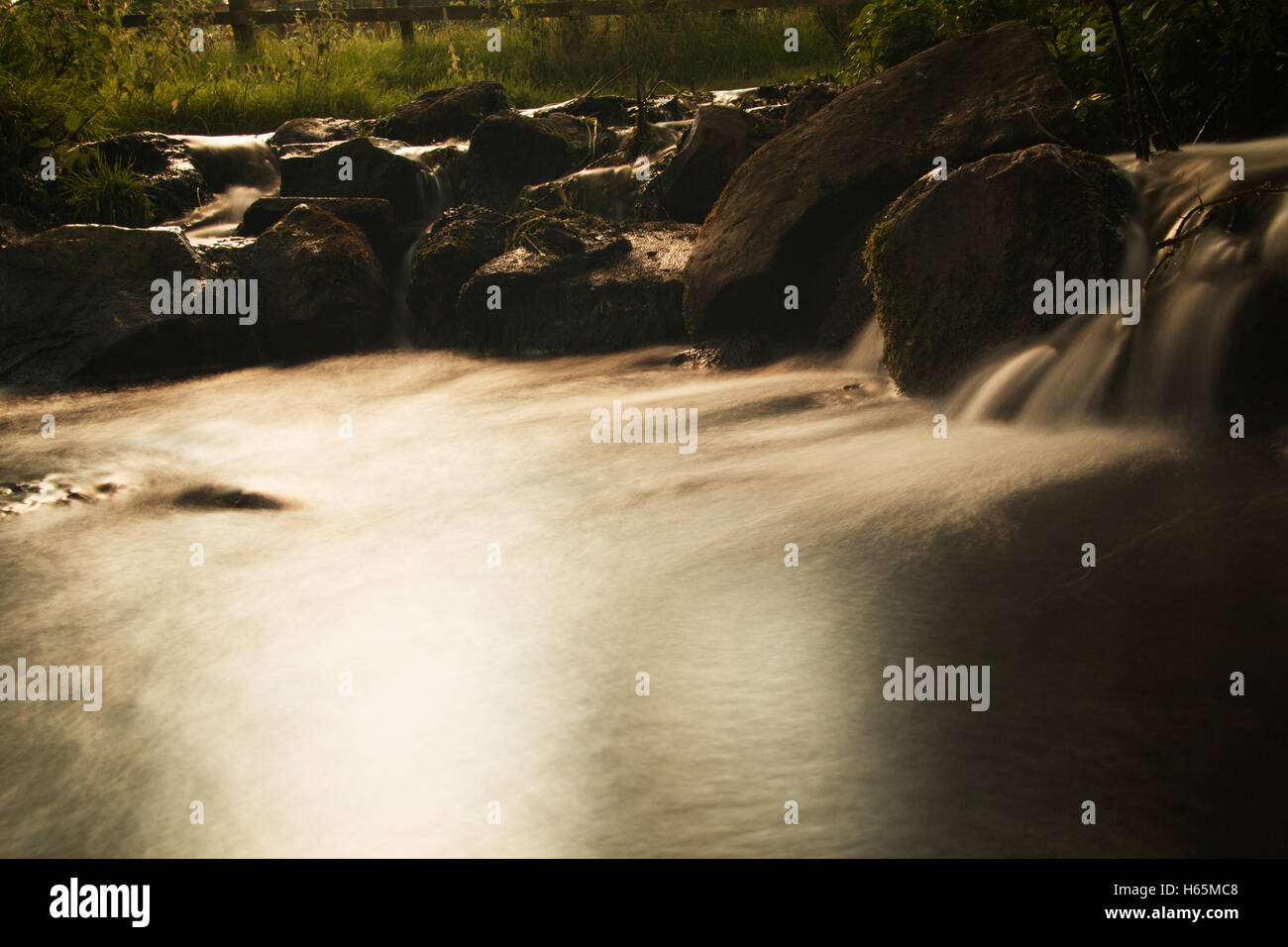 Long exposure shot of a waterfall in a small country stream Stock Photo ...