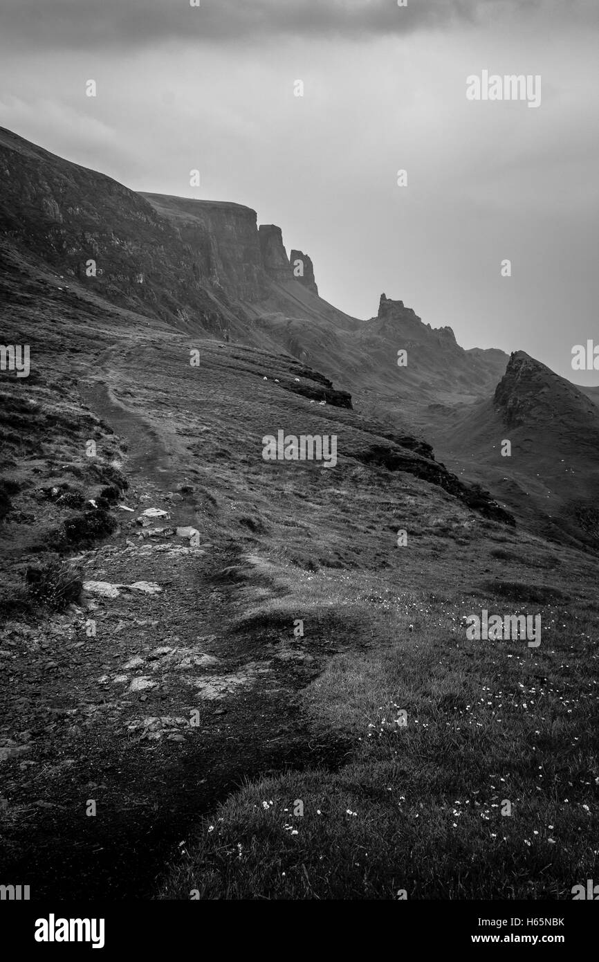 Hiking Path On The Quiraing, Isle of Skye, Scotland With Mountain Peaks In The Distance - Dramatic Black and White Look Stock Photo