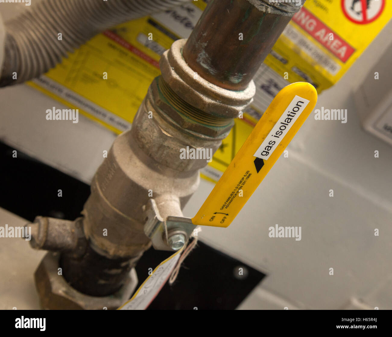 A gas isolation valve, bright yellow, with warning signs Stock Photo Alamy
