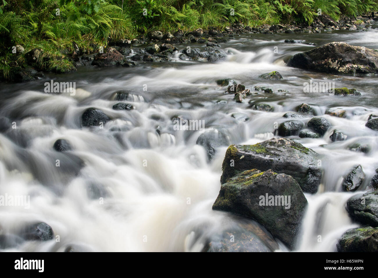 Detail of water flowing over boulders in the River Garry in Glengarry Forest, Lochaber, Scottish Highlands, Scotland Stock Photo