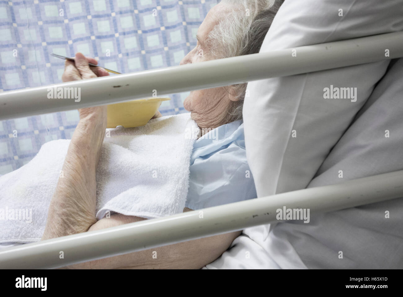 Ninety year old female patient eating in bed in Nation Health Service Hospital in England, United Kingdom. Stock Photo