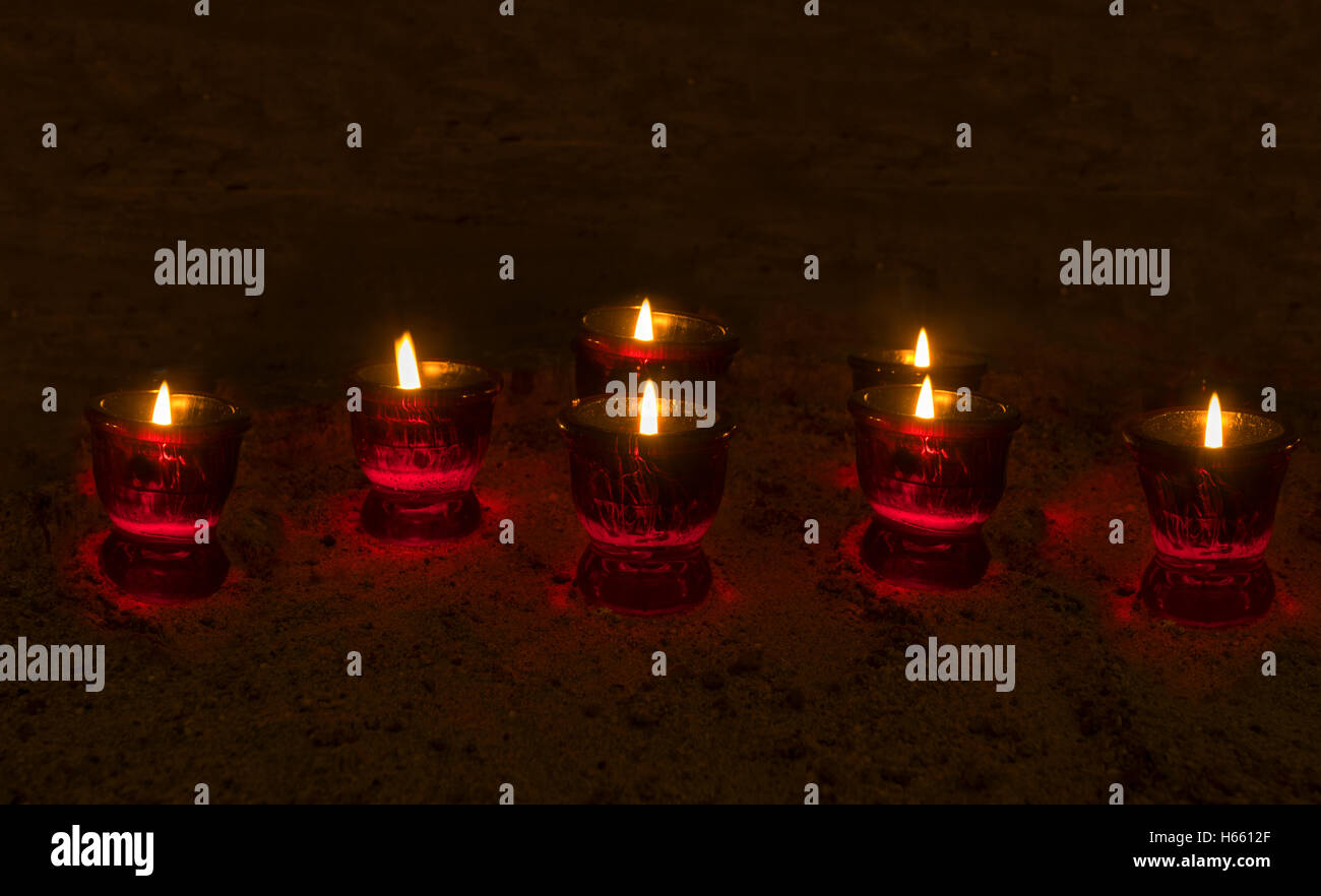 Burning votive candles in a dark room Stock Photo Alamy
