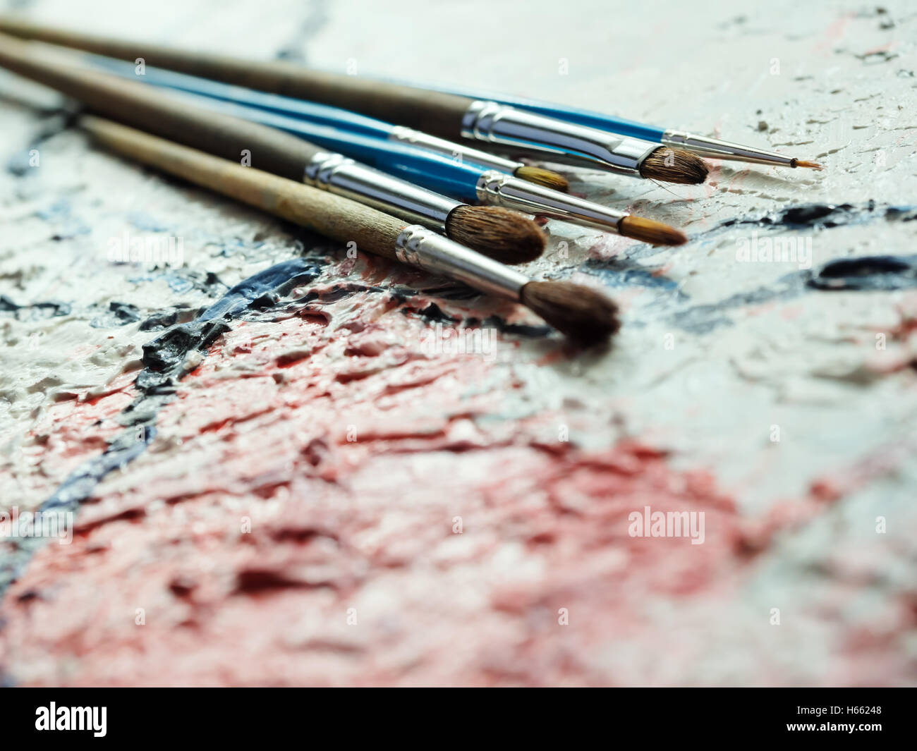 Paintbrushes on oil painting canvas. Shallow depth of field Stock Photo -  Alamy