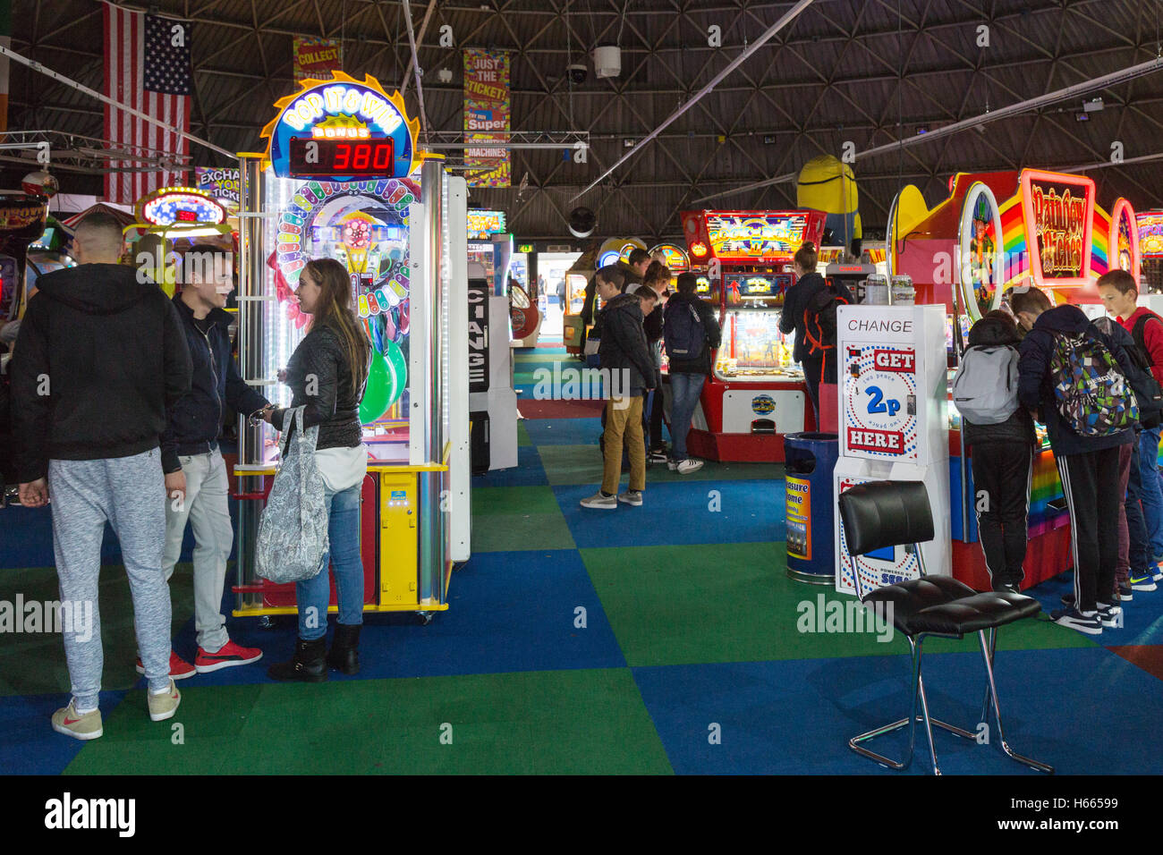 Teenagers in the amusements arcade, Brighton Pier, Brighton, East Sussex England UK Stock Photo