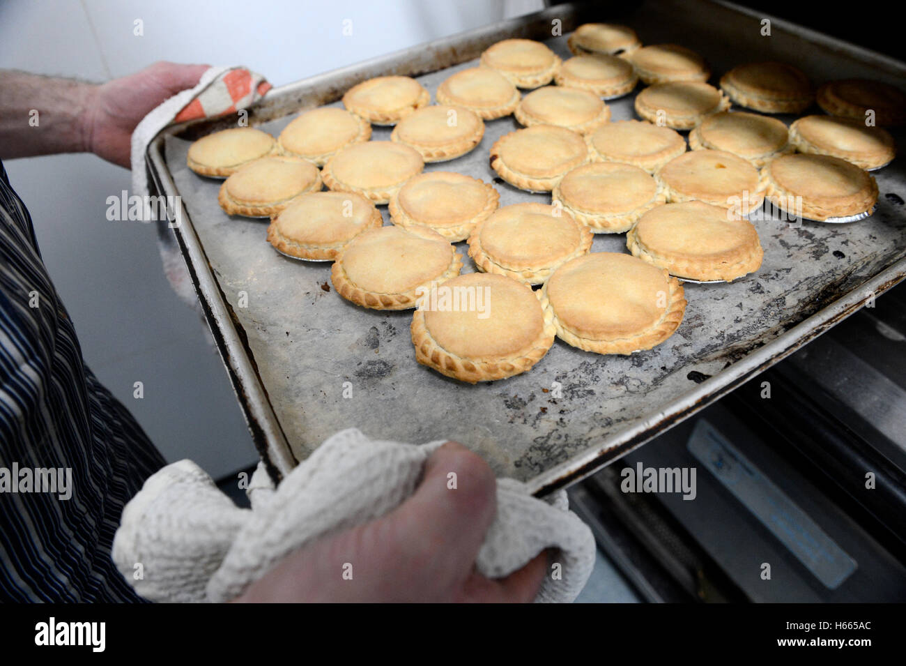 Baker making recipes and baking cakes and loaves in an oven Stock Photo