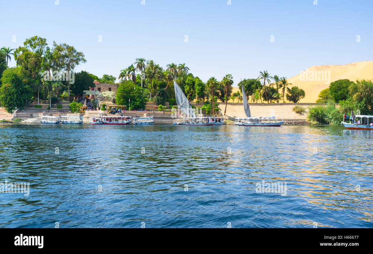 The motor boats and feluccas moored next to the entrance to Botanical garden on the Kitchener's island, Aswan, Egypt. Stock Photo