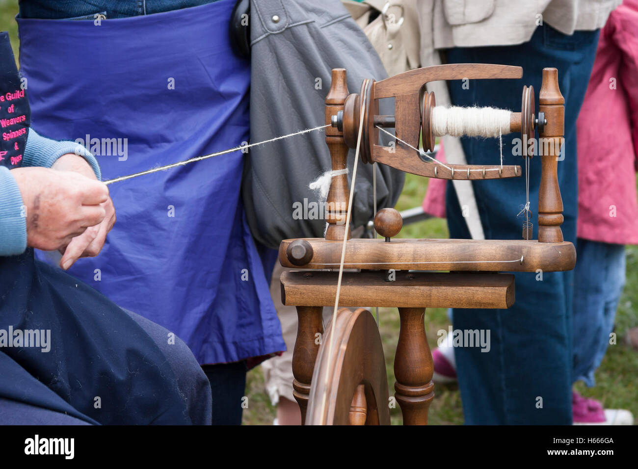 skillful lady using spinning wheel Stock Photo Alamy