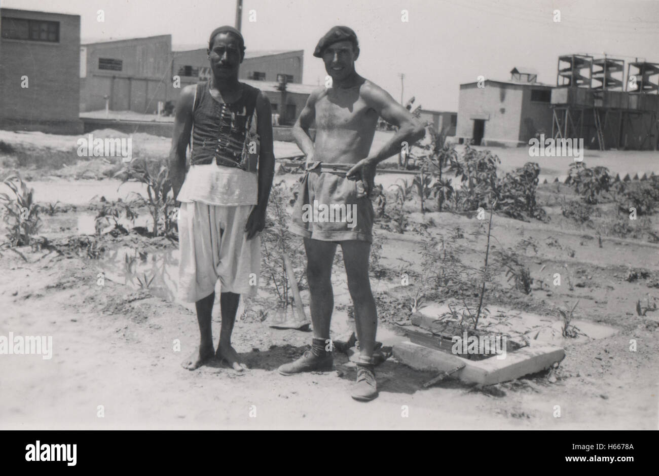 British army personnel and Egyptian civilian inside 10 Base Ordnance Depot Royal Army Ordnance Corps (RAOC) camp at Geneifa Ismailia area near the Suez Canal 1952 in the period prior to withdrawal of British troops from the Suez Canal zone and the Suez Crisis. Photographer and engineer Basil James Wheldon in the photo with Mahmoud Mohamed Asleit Stock Photo