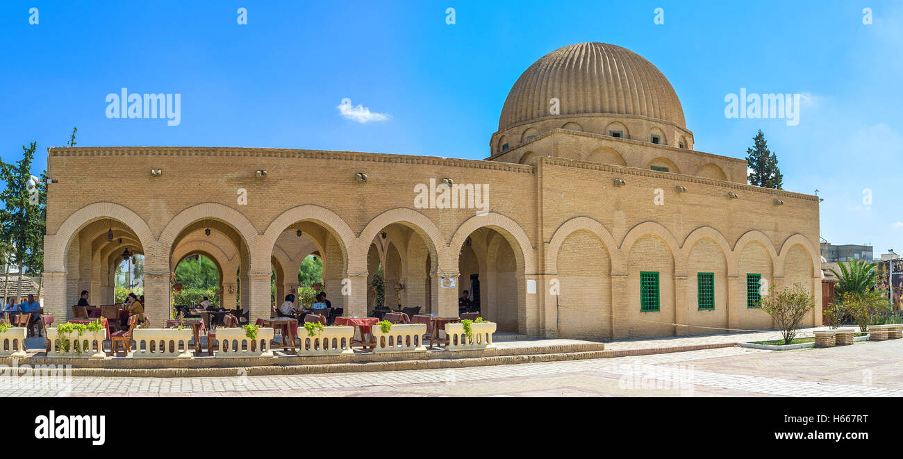 The building of the old mausoleum rebuild into the cafe with large shady terrace, Kairouan Tunisia Stock Photo