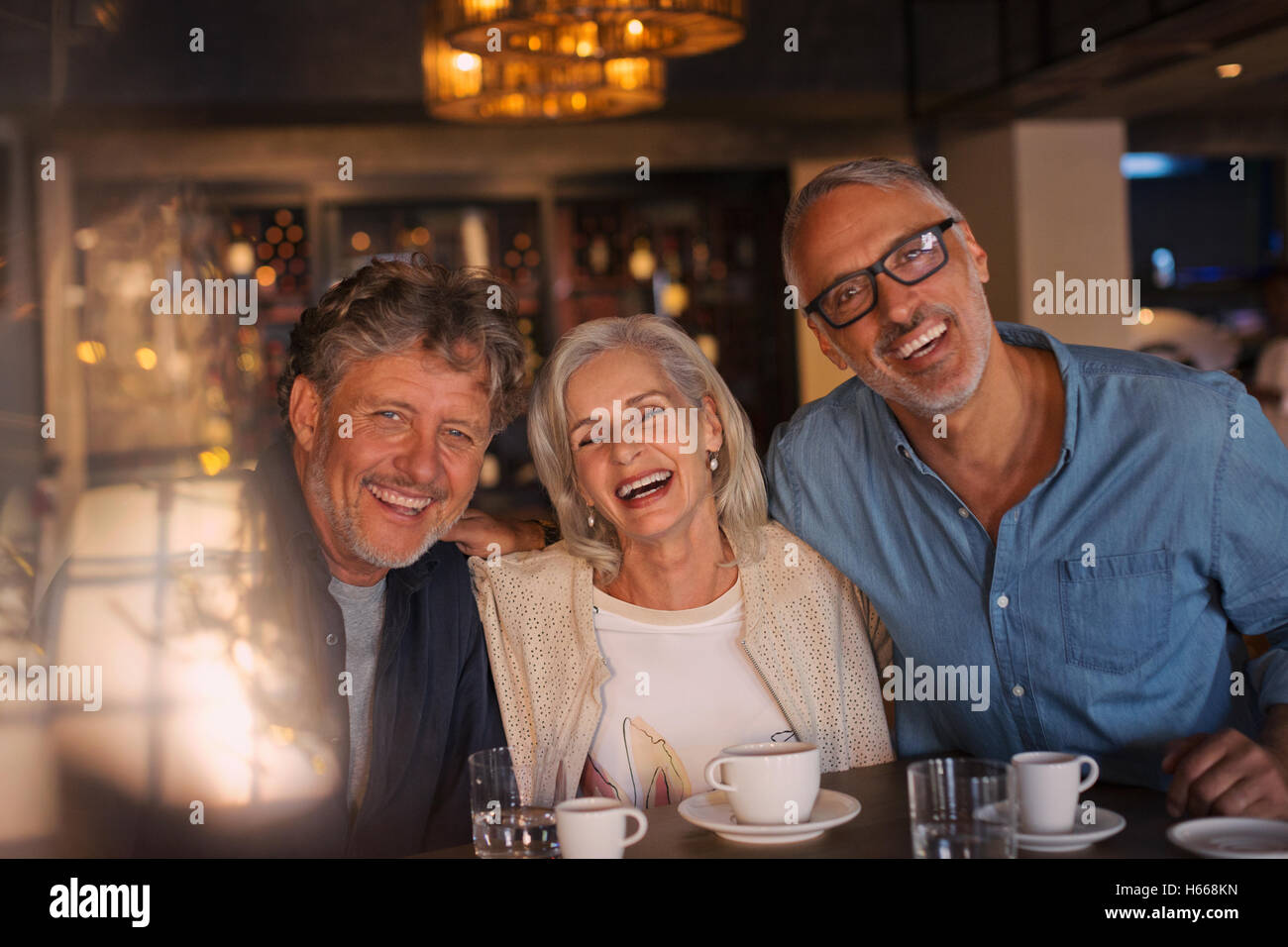 Portrait laughing friends drinking coffee in restaurant Stock Photo