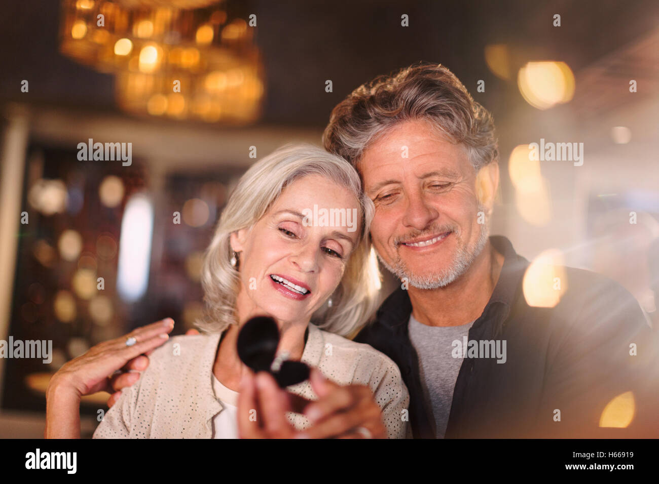 Senior woman receiving jewelry gift from husband Stock Photo