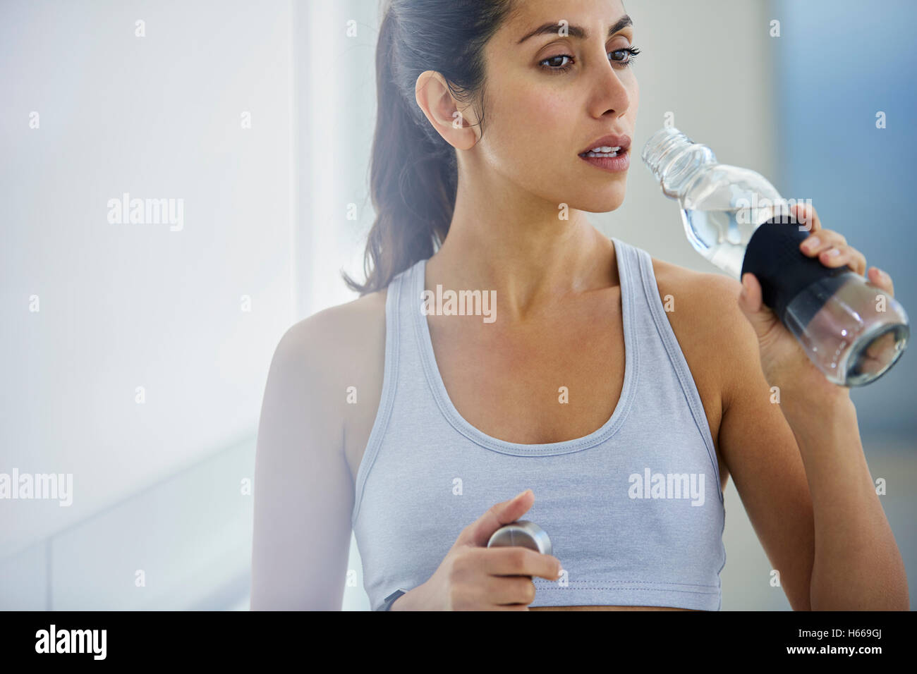 Woman drinking water post workout Stock Photo Alamy