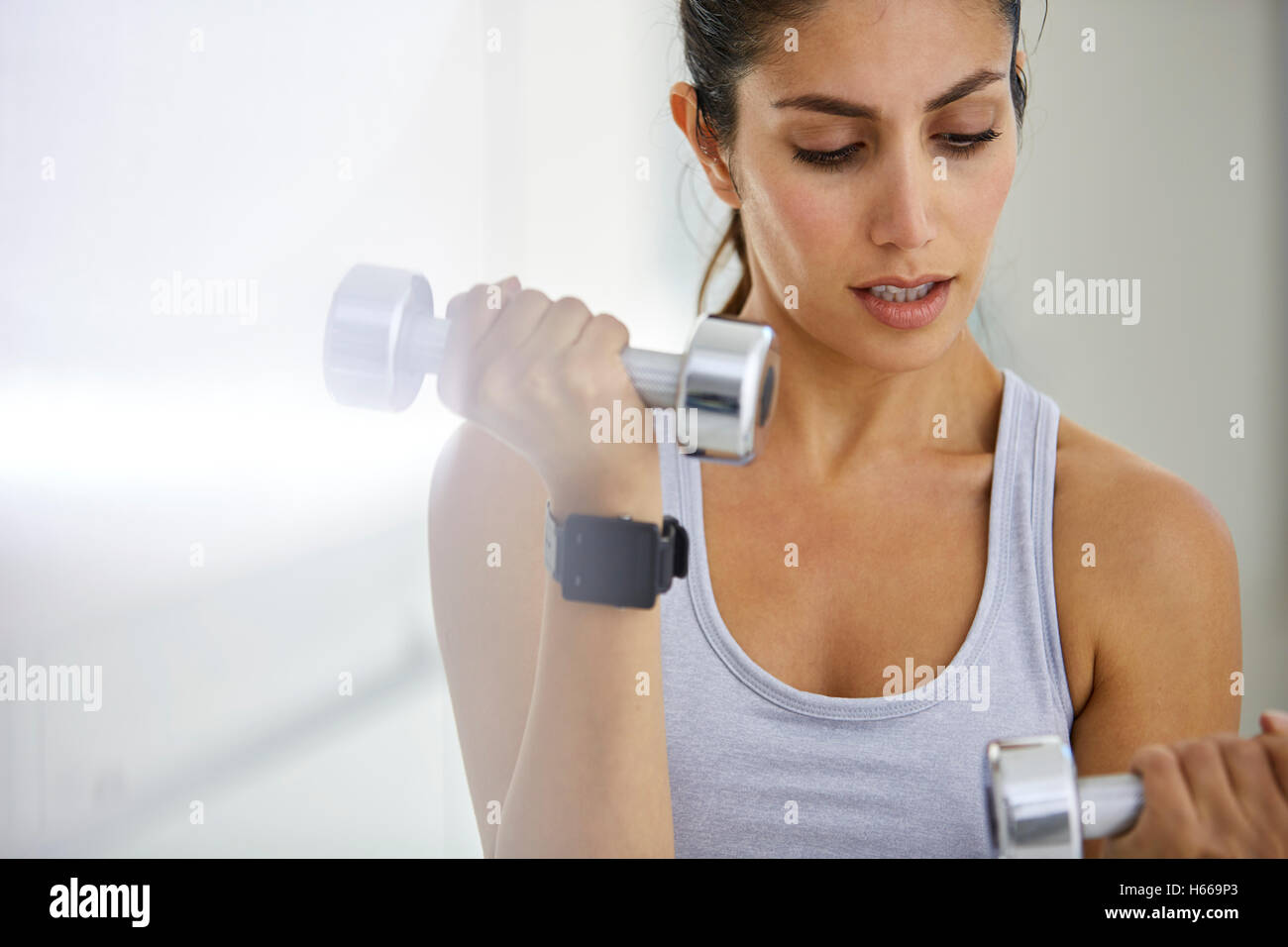 Young Woman Exercising Biceps With Dumbbells In The Gym And Flexing Muscles  - Muscular Athletic Bodybuilder Fitness Model Doing Dumbbell Concentration  Curls Stock Photo, Picture and Royalty Free Image. Image 81263216.