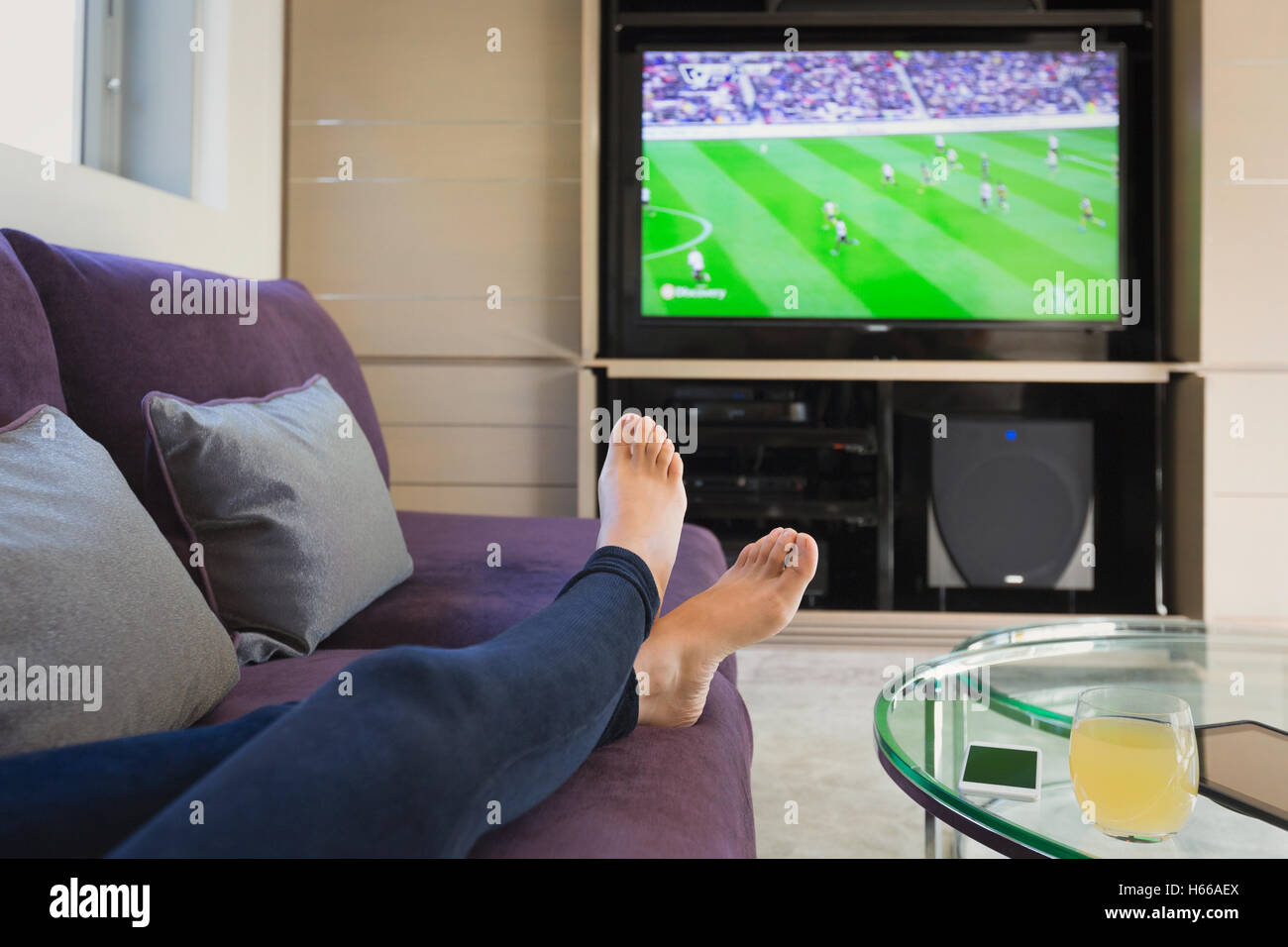 Personal Perspective Woman With Bare Feet Up Watching Soccer Game On Tv 