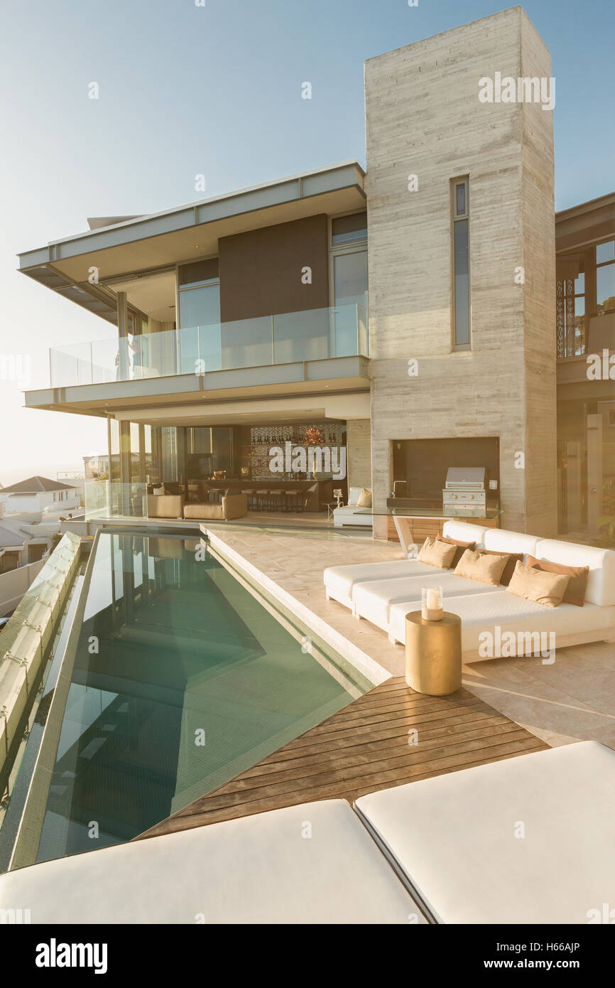 Sunny modern luxury home showcase exterior with lap pool Stock Photo ...