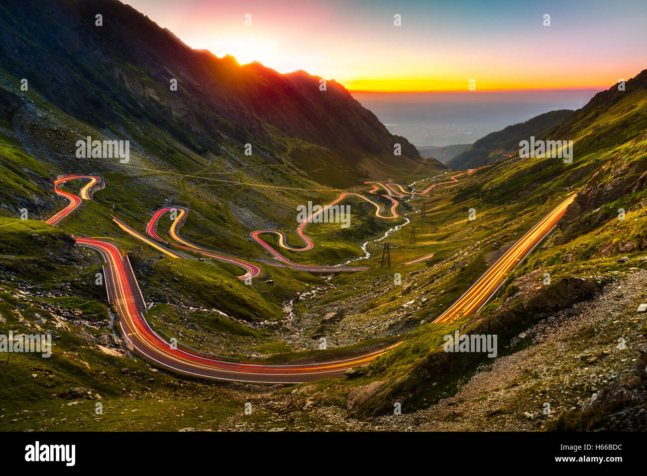 Traffic trails on Transfagarasan pass at sunset. Stock Photo