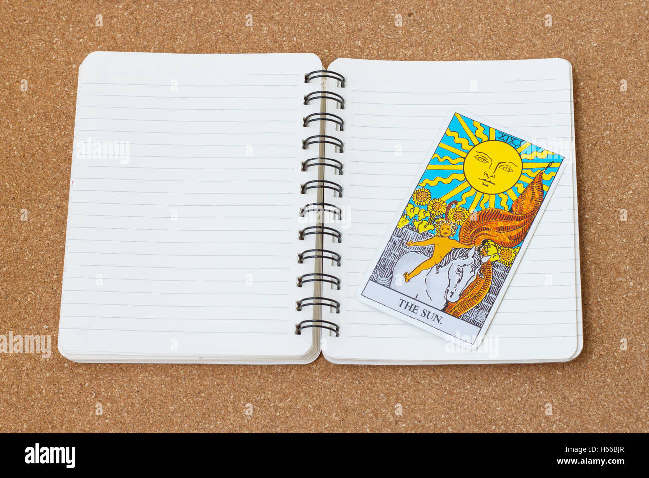 Tarot card 'The Sun' with notebook and space. Stock Photo