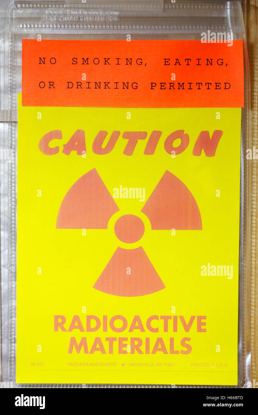Radioactive material warning sign on laboratory door. Stock Photo