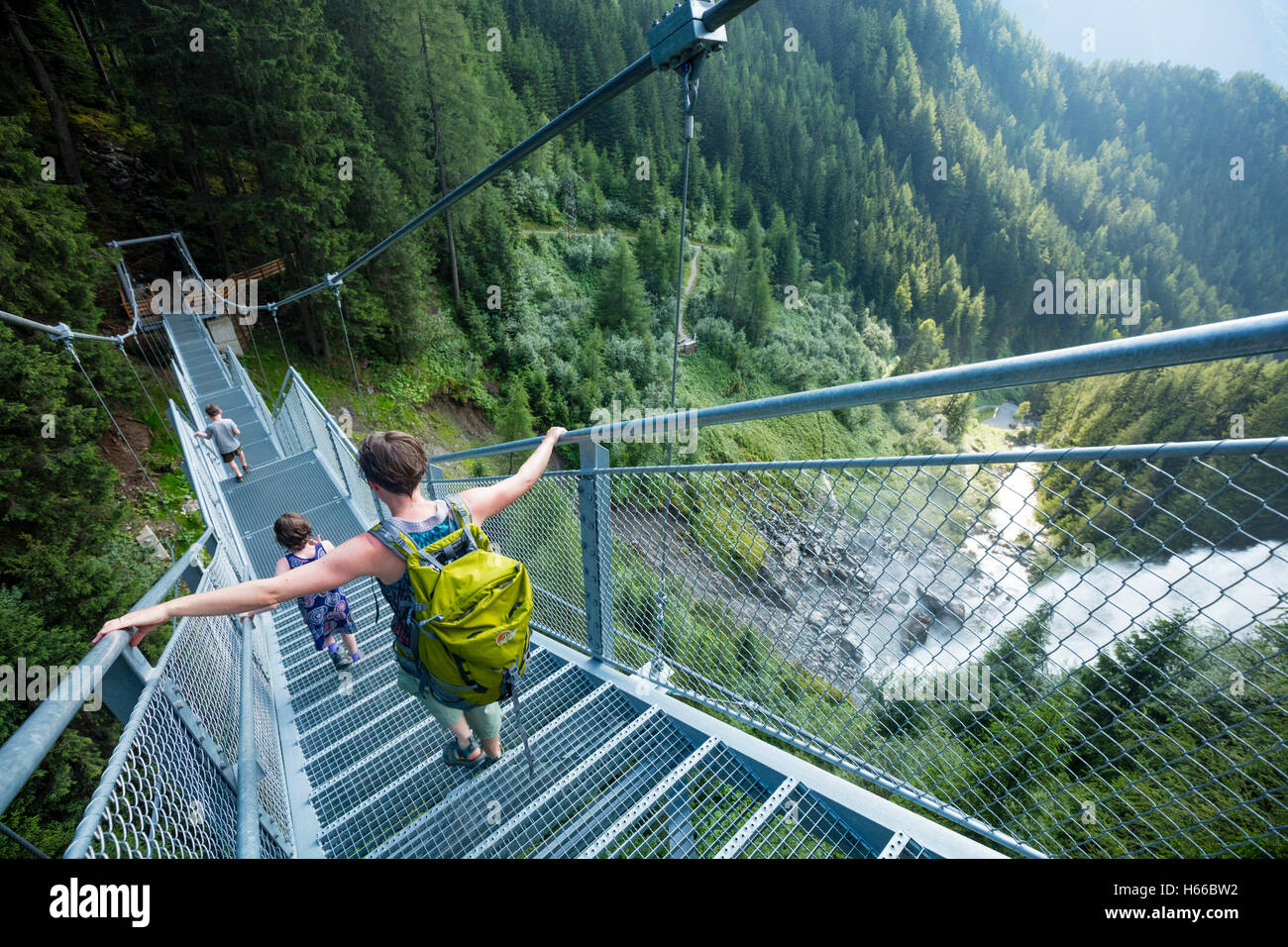 Tourists descending the suspended metal stairway beside Stuibenfall waterfall, Otztal, Valley, Tirol, Austria. Stock Photo