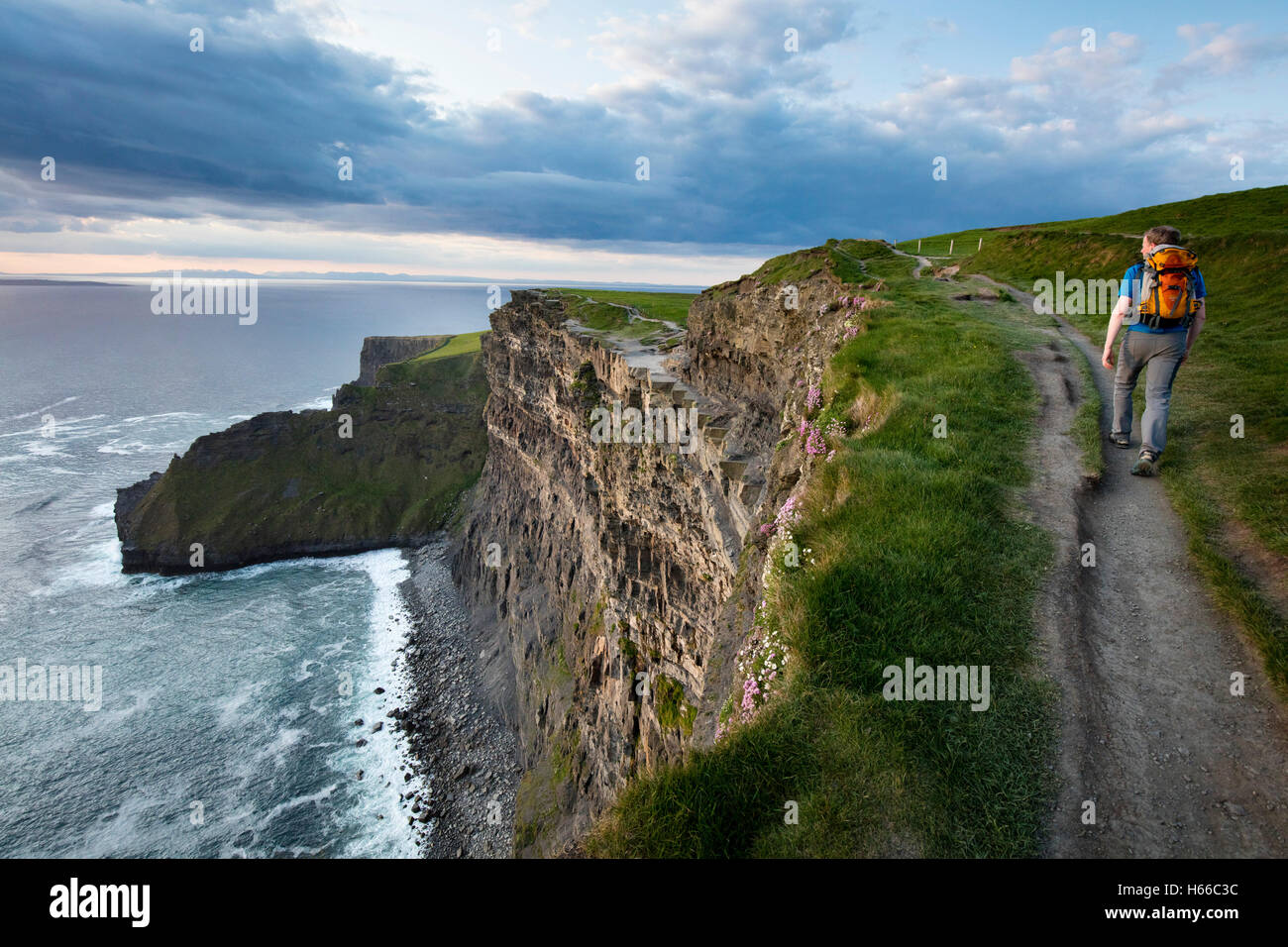 Hiker on top of the Cliffs of Moher, County Clare, Ireland. Stock Photo
