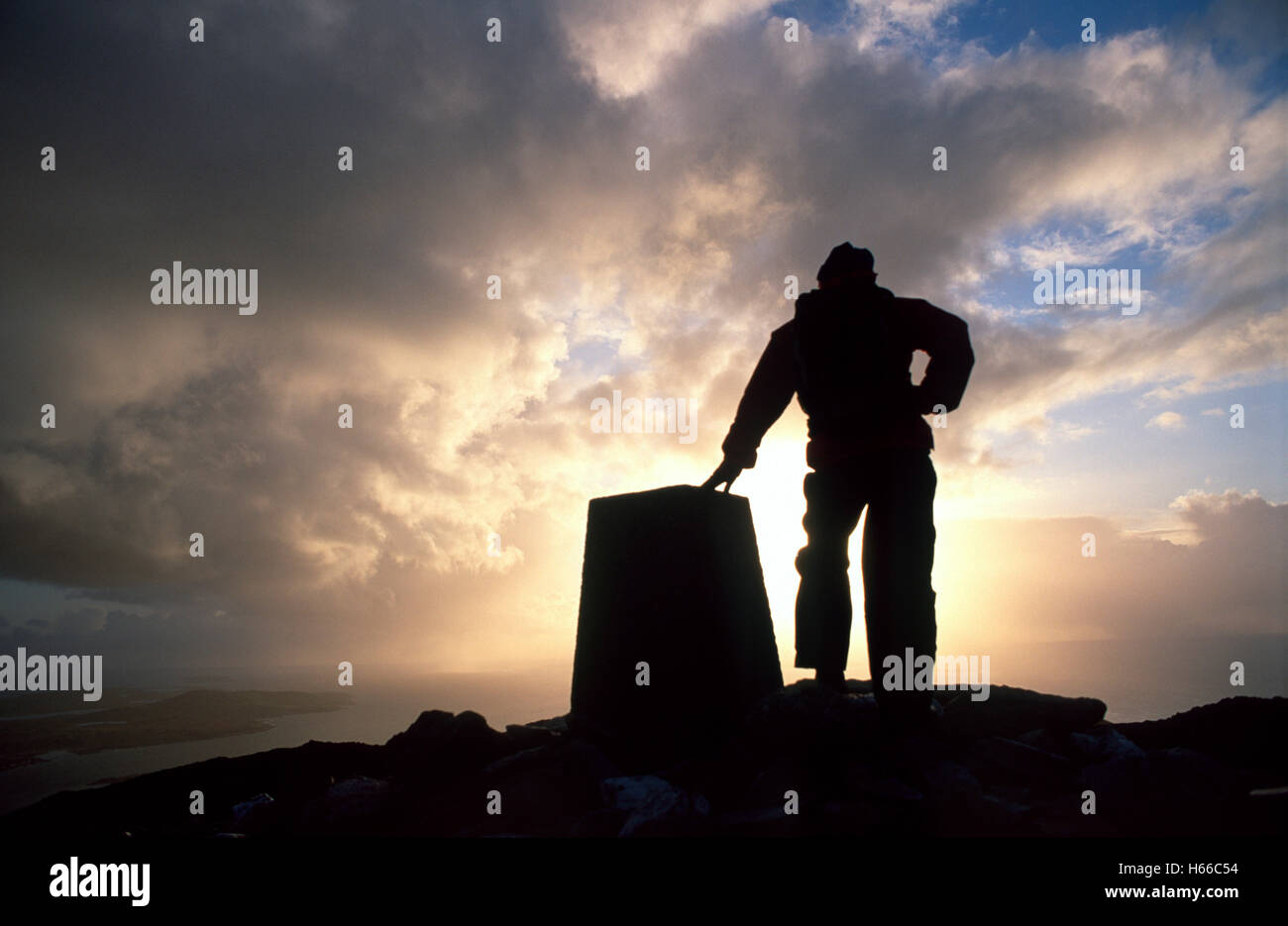 Silhouette of walker at the summit of Tully Mountain, Connemara, County Galway, Ireland. Stock Photo