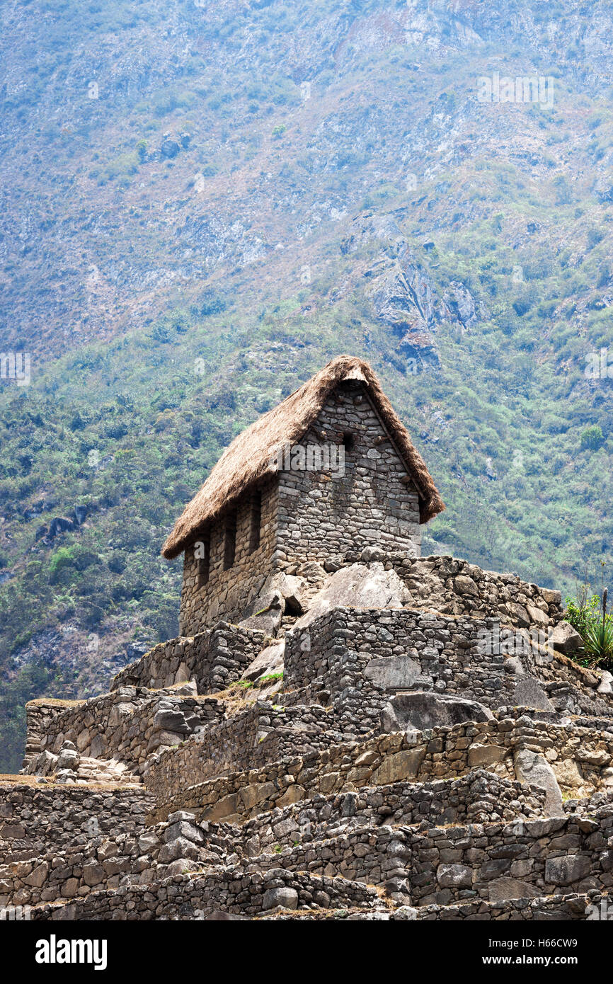 ancient house in Machu Picchu mountains in the background Stock Photo ...