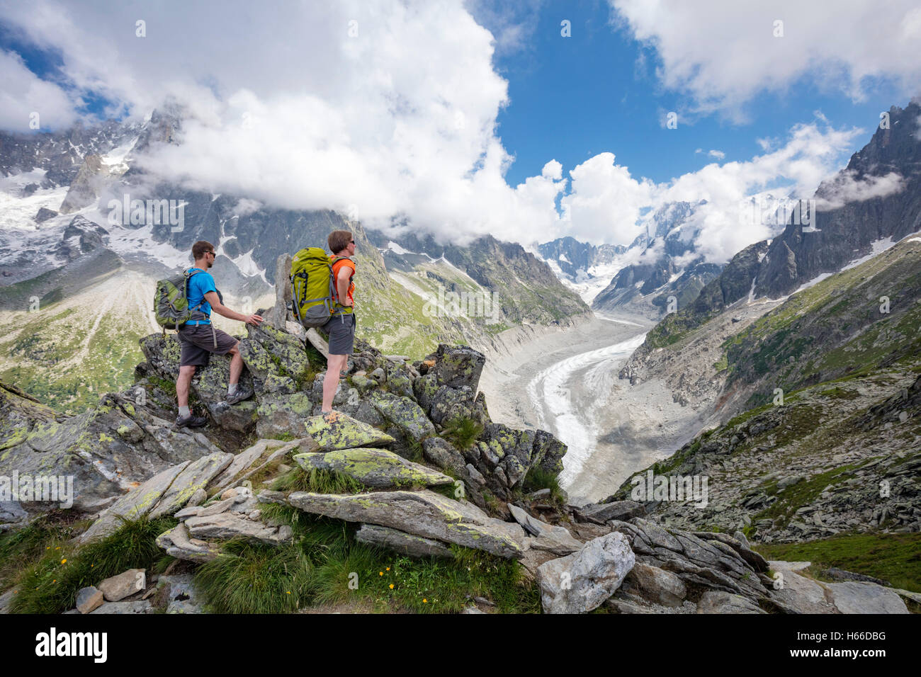 Hikers looking across Mer de Glace glacier from Signal Forbes, Montenvers. Chamonix Valley, French Alps, France. Stock Photo