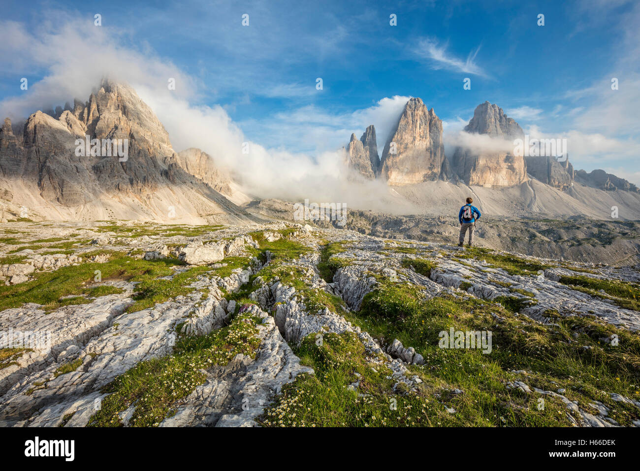 Hiker beneath Tre Cime di Lavaredo, Sexten Dolomites, South Tirol, Italy. Stock Photo