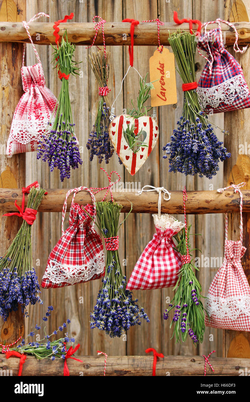 different varieties lavender and fragrant sacs hanging as decoration on a wooden ladder Stock Photo