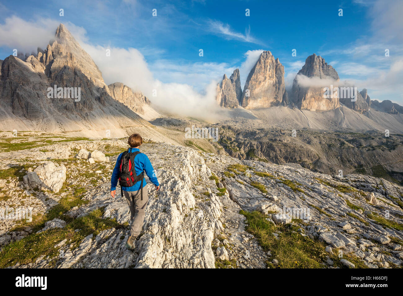 Hiker beneath Tre Cime di Lavaredo, Sexten Dolomites, South Tirol, Italy. Stock Photo