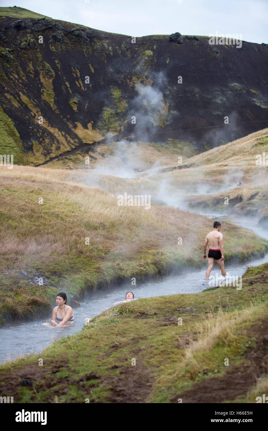 People bathe in the geotermally heated water of an Icelandic river at ...