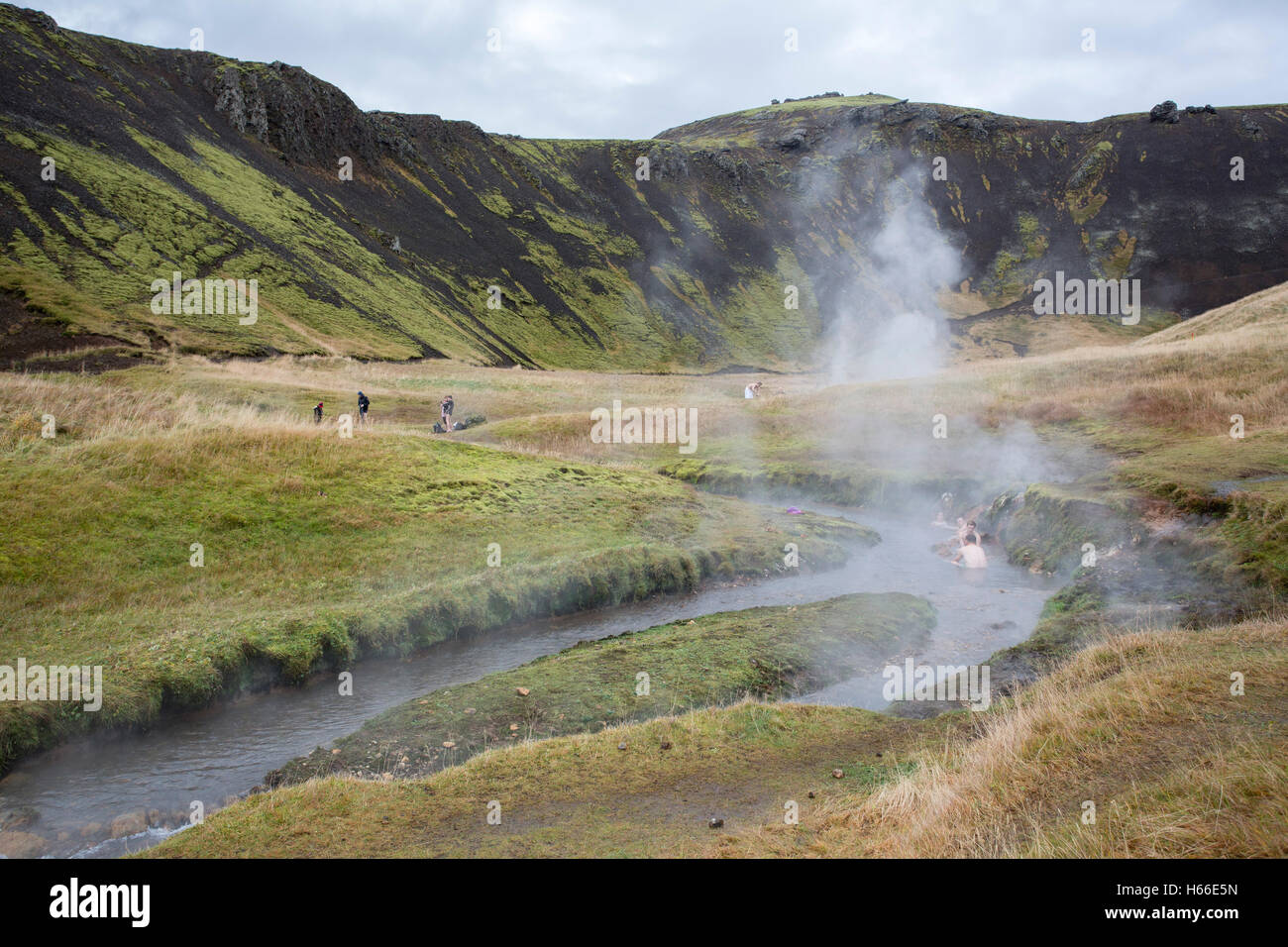 People bathe in the geotermally heated water of an Icelandic river at ...