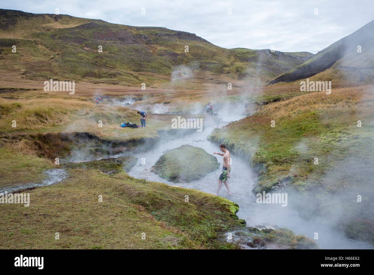 People bathe in the geotermally heated water of an Icelandic river at ...