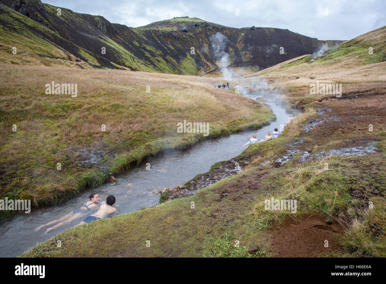 People bathe in the geotermally heated water of an Icelandic river at ...