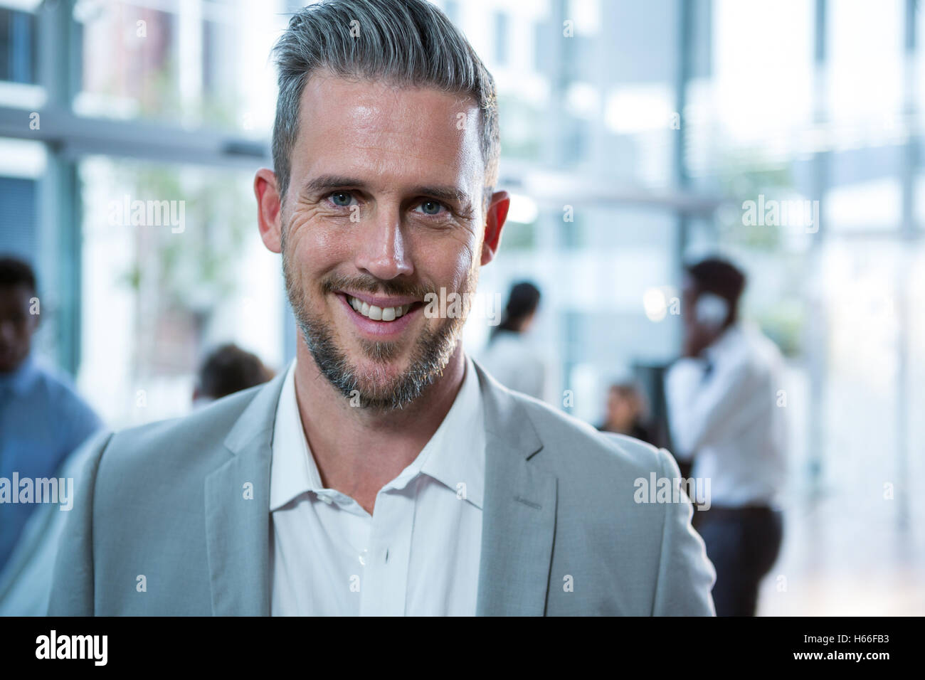 Portrait of smiling businessman Stock Photo - Alamy