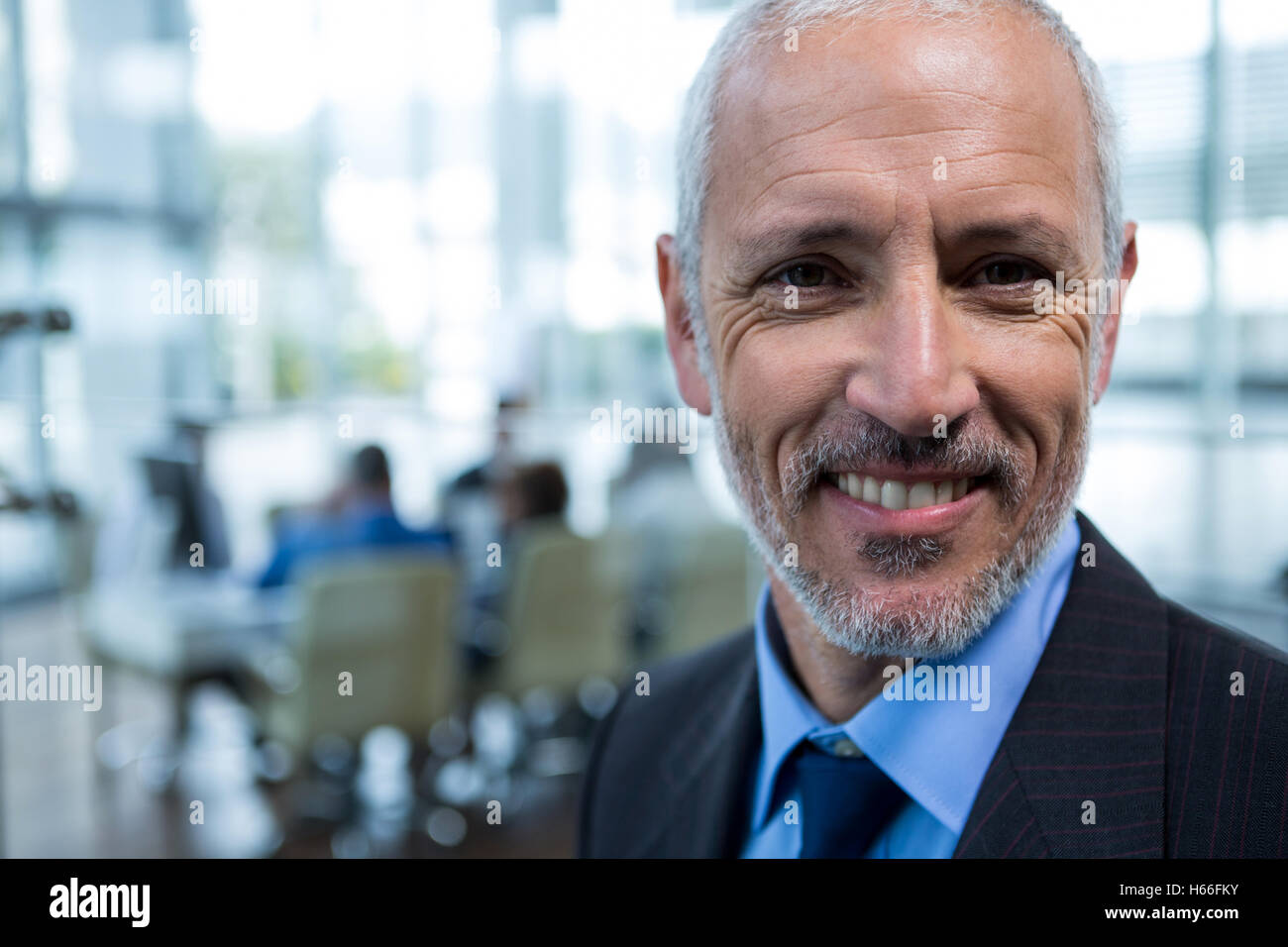 Smiling businessman in office Stock Photo - Alamy