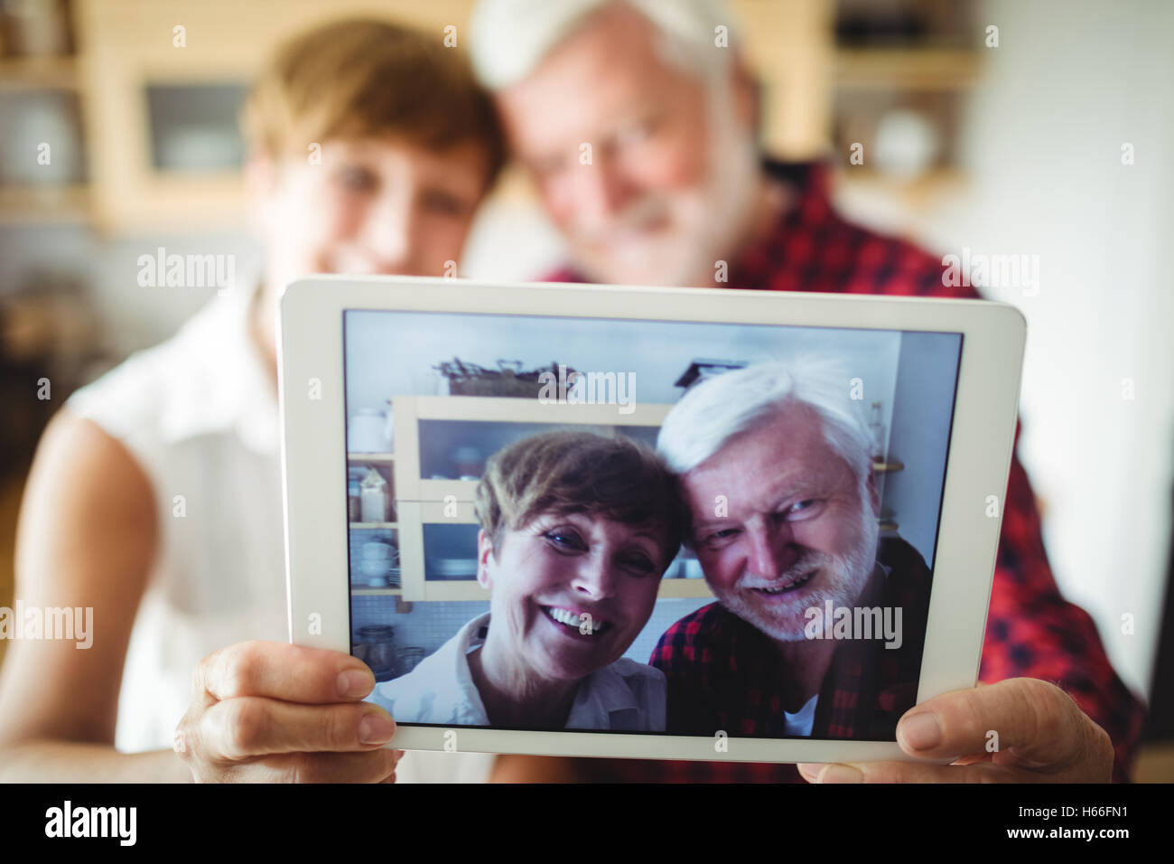 Senior couple clicking a picture on digital tablet Stock Photo