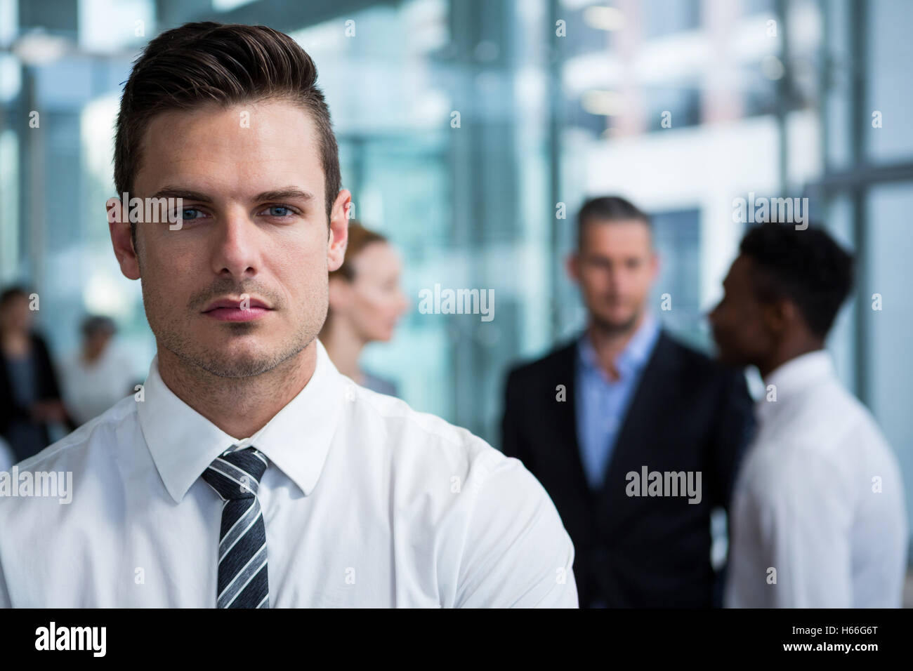 Businessman standing in office building Stock Photo