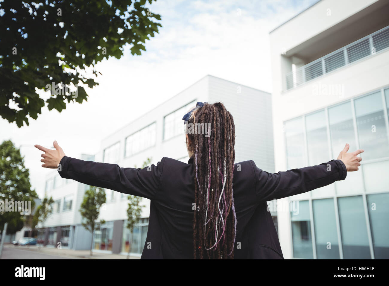 Businesswoman standing with arms outstretched Stock Photo